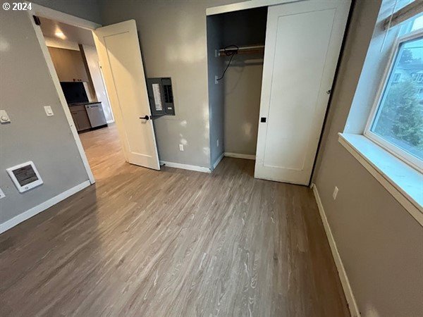 unfurnished bedroom with light hardwood / wood-style flooring and a closet