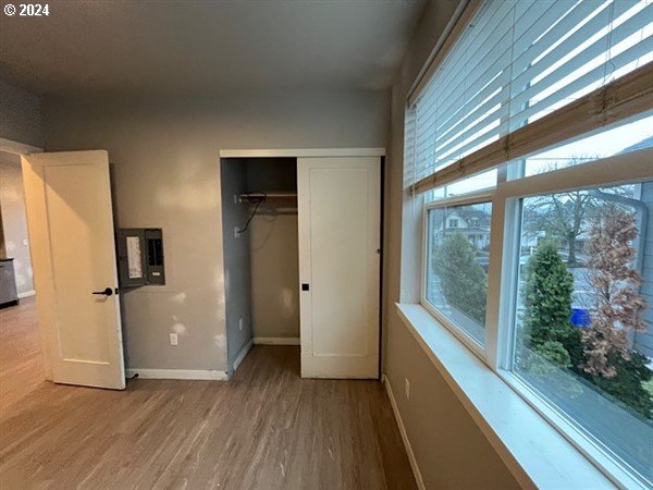 unfurnished bedroom featuring light hardwood / wood-style flooring and a closet