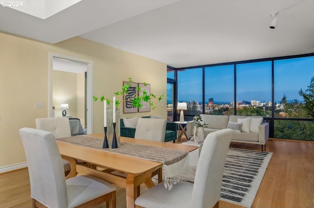 dining space featuring light hardwood / wood-style flooring and expansive windows