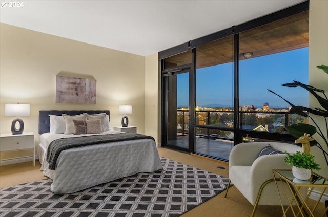 bedroom featuring carpet flooring, floor to ceiling windows, and access to exterior