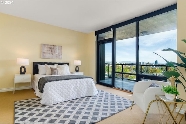 carpeted bedroom featuring access to outside and a wall of windows