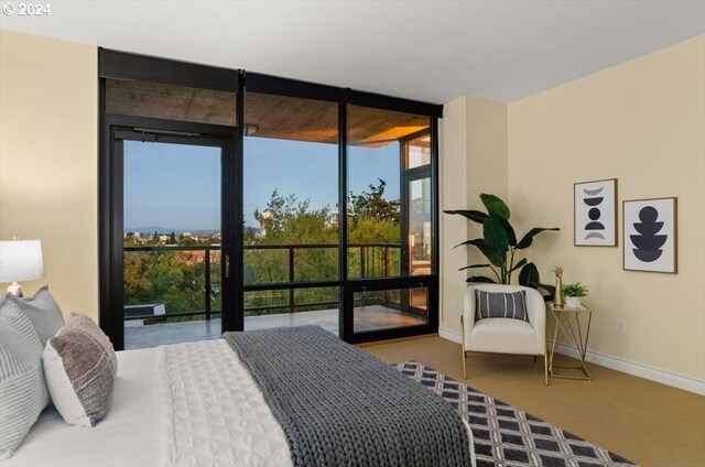 carpeted bedroom featuring multiple windows and access to exterior