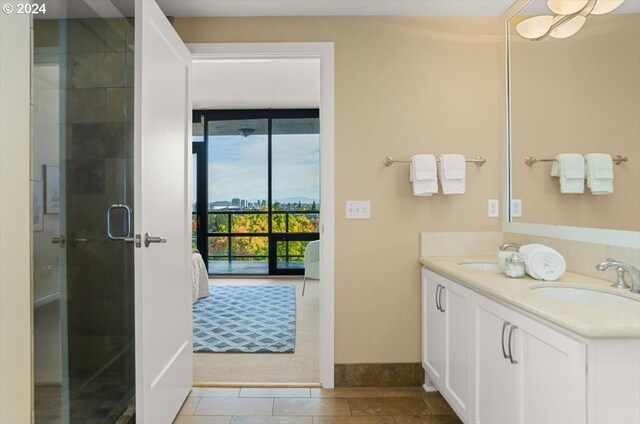 bathroom with tile patterned flooring, vanity, and an enclosed shower