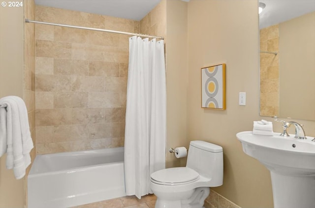 2442 NW Westover Rd Unit 3-202, Portland, OR 97210 - bathroom featuring tile patterned flooring, toilet, shower / bath combo with shower curtain, and a sink