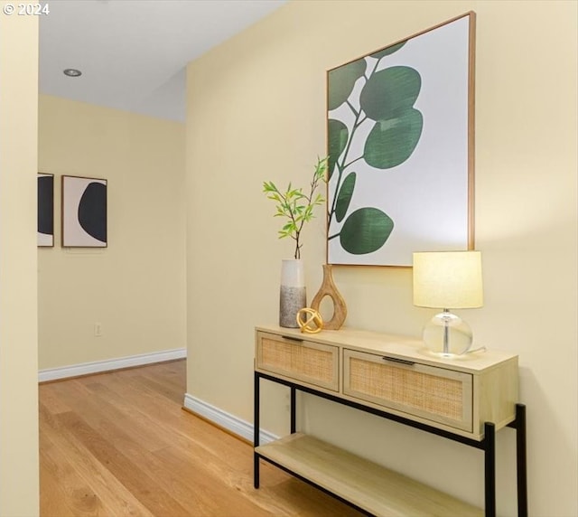 hallway with light hardwood / wood-style flooring