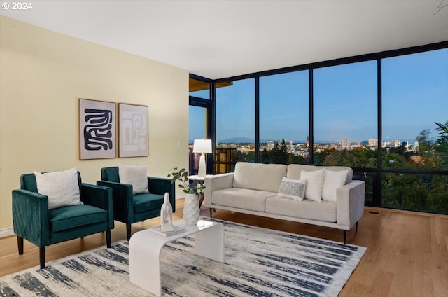 living room featuring hardwood / wood-style flooring and a wall of windows