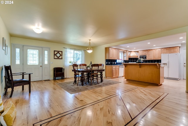 dining space with light hardwood / wood-style floors