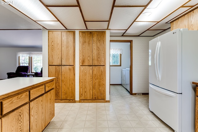 39431 Walterville Ln, Springfield, OR 97478 - kitchen with freestanding refrigerator, light floors, light countertops, washing machine and dryer, and baseboards