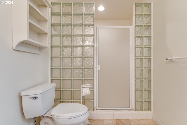 bathroom featuring a shower and toilet