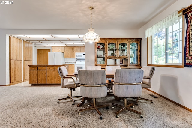 dining area featuring light colored carpet