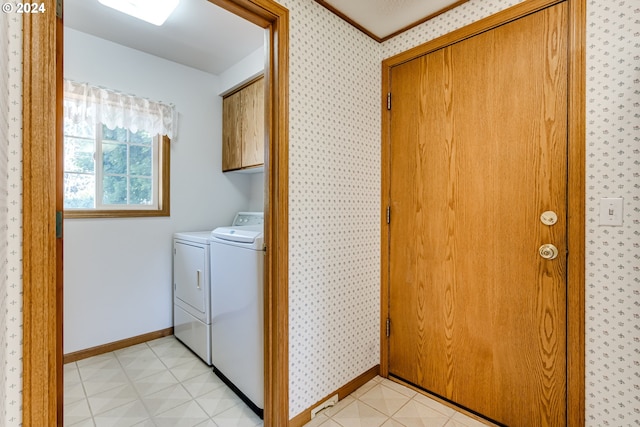 washroom with separate washer and dryer, cabinets, and light tile patterned flooring