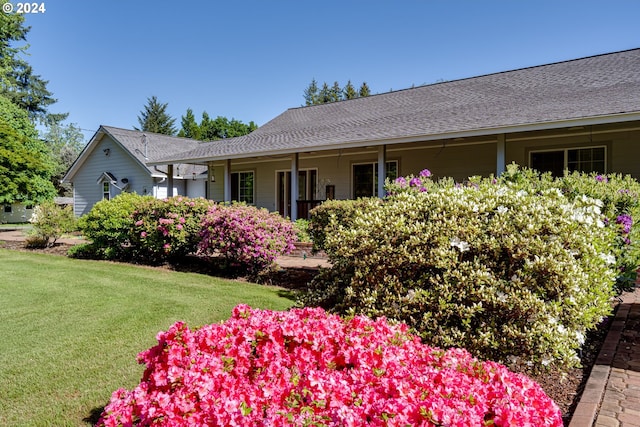 view of side of home with a lawn