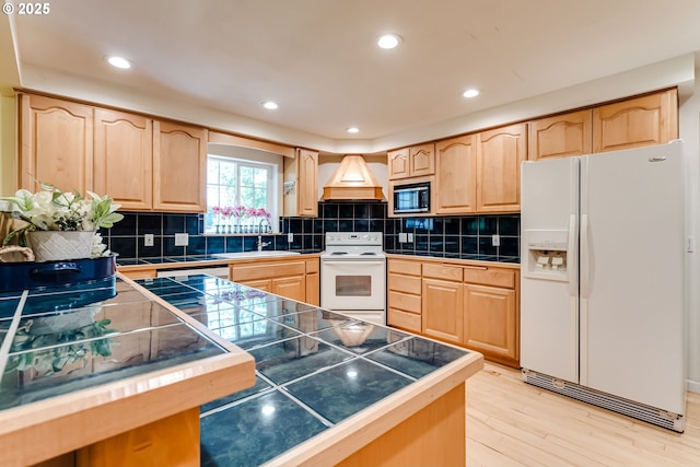 39431 Walterville Ln, Springfield, OR 97478 - kitchen featuring white appliances, light brown cabinetry, premium range hood, light wood-style flooring, and recessed lighting