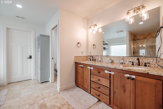 bathroom with decorative backsplash, vanity, toilet, and a shower with shower door