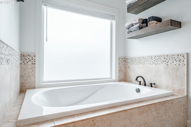 bathroom featuring tiled bath