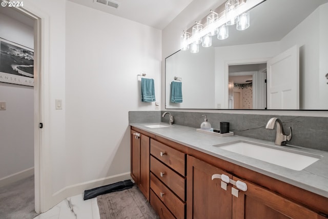 bathroom featuring tasteful backsplash and vanity