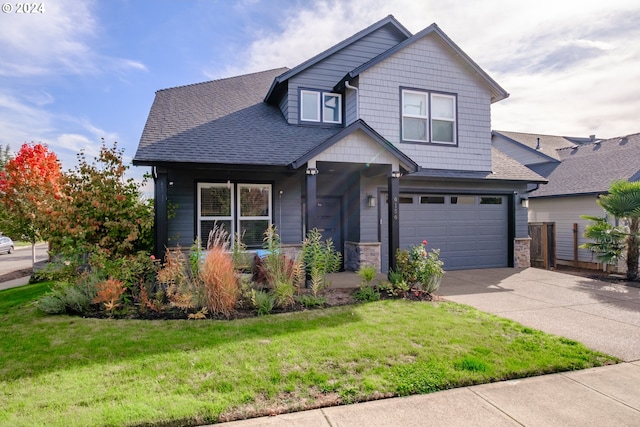 craftsman inspired home with a garage and a front lawn