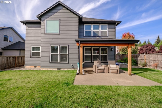 rear view of house with a yard and a patio