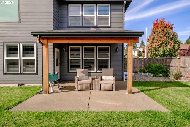 rear view of property featuring a patio area and a yard