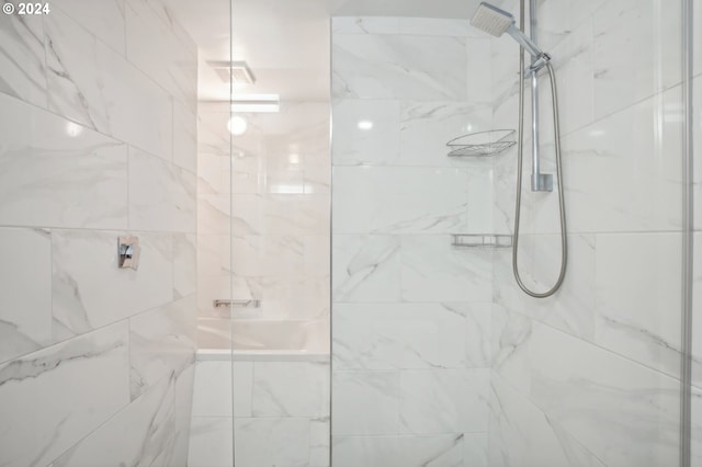 bathroom with a tile shower