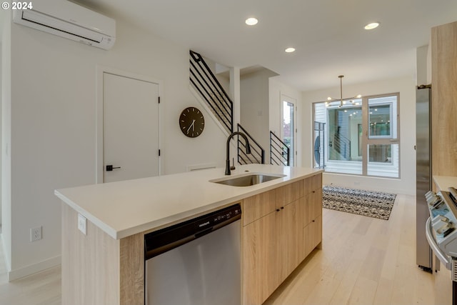 kitchen with sink, a center island with sink, dishwasher, a wall mounted AC, and light wood-type flooring