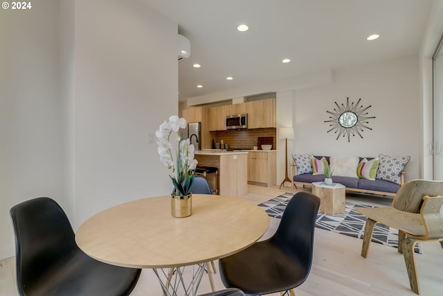 dining room with light hardwood / wood-style flooring