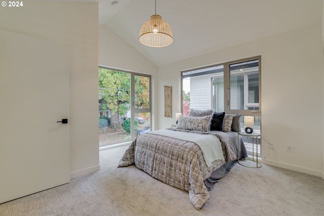 bedroom with light carpet and high vaulted ceiling