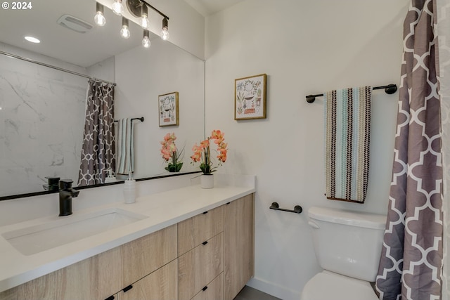 bathroom with vanity with extensive cabinet space and toilet