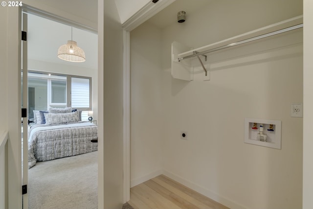 washroom with light colored carpet, hookup for a washing machine, and electric dryer hookup