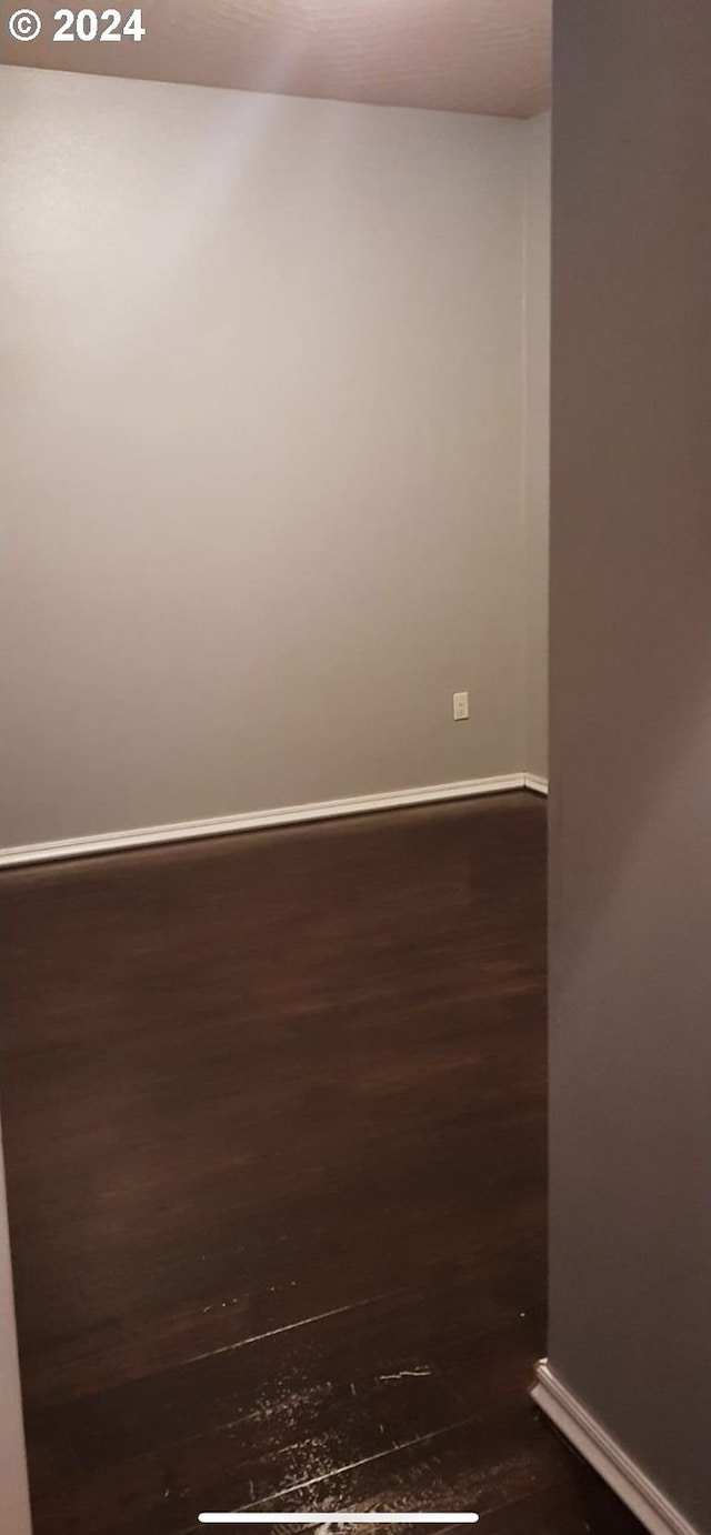 unfurnished room featuring dark hardwood / wood-style flooring