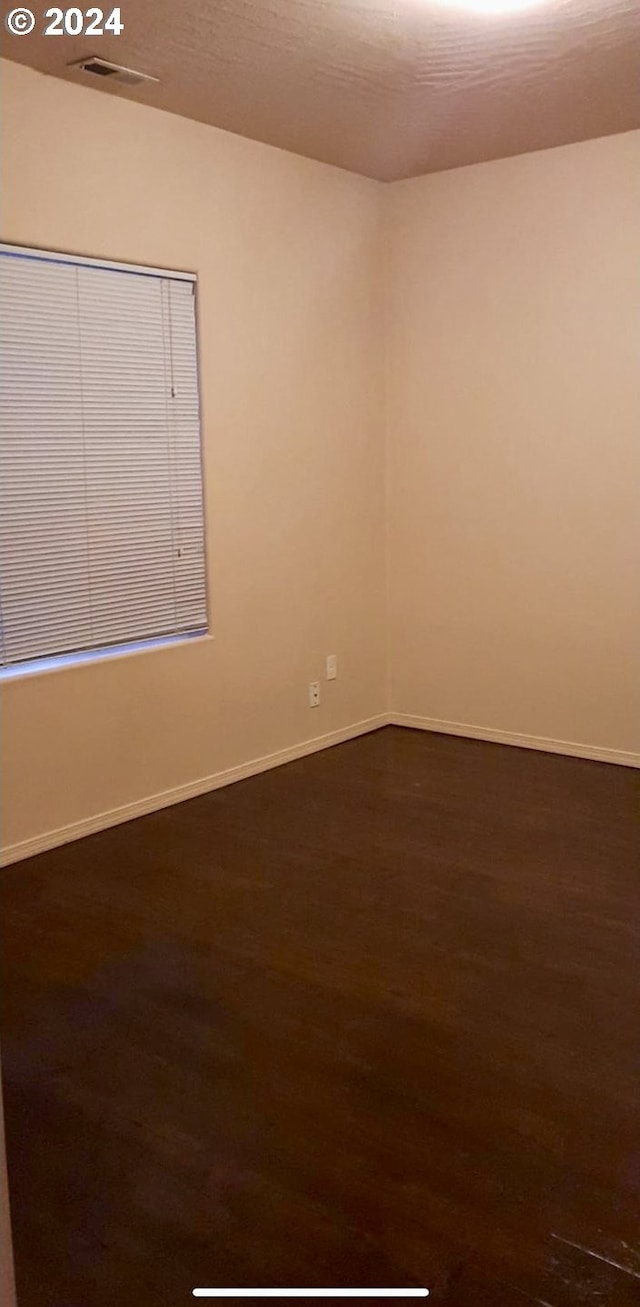 empty room with dark hardwood / wood-style floors