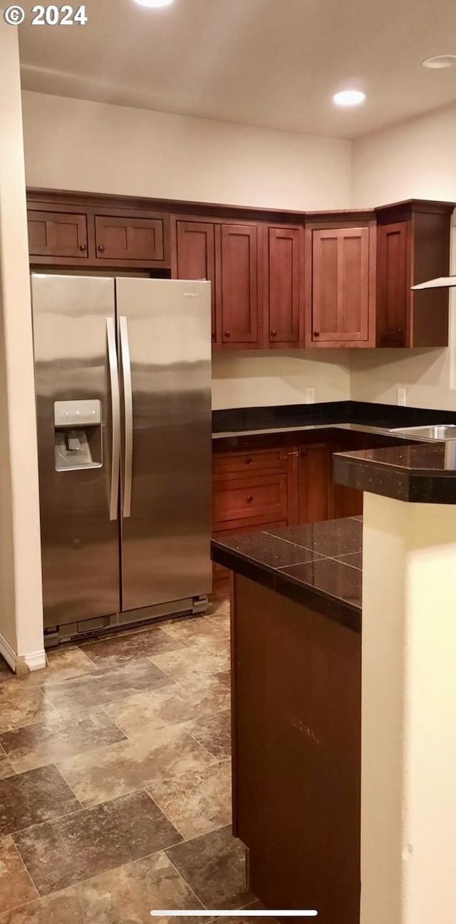 kitchen featuring stainless steel fridge with ice dispenser