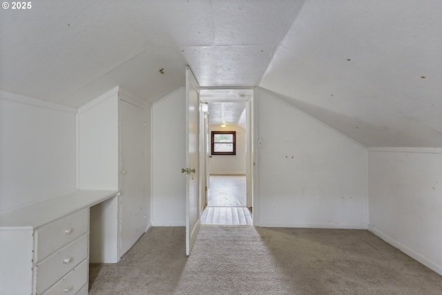 bonus room featuring light carpet and lofted ceiling