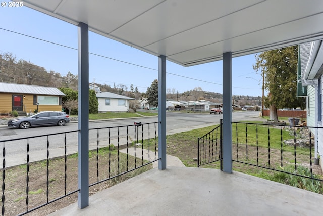 view of patio / terrace with a residential view and fence