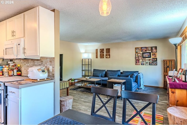 living room with a textured ceiling and hardwood / wood-style floors