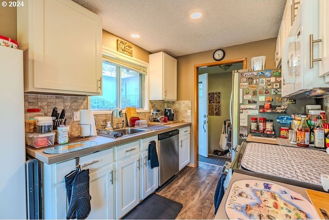 kitchen featuring white cabinets, dark hardwood / wood-style flooring, a textured ceiling, stainless steel dishwasher, and sink