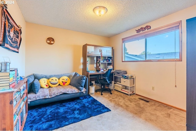 bedroom with a textured ceiling and carpet