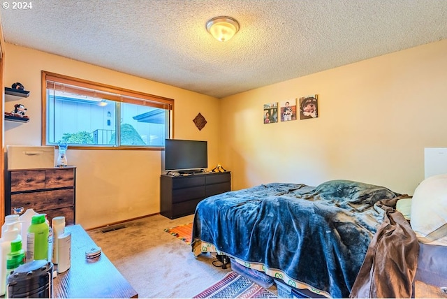 carpeted bedroom featuring a textured ceiling