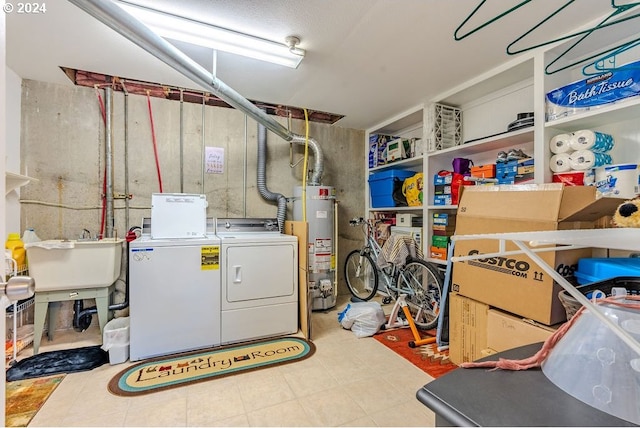 laundry room with washer and clothes dryer, water heater, and sink