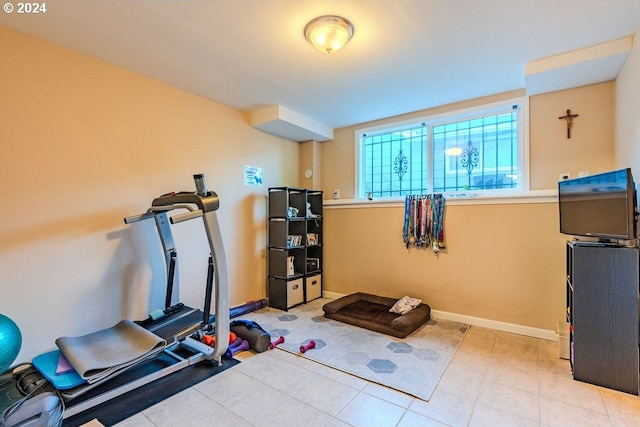 exercise area featuring light tile patterned floors