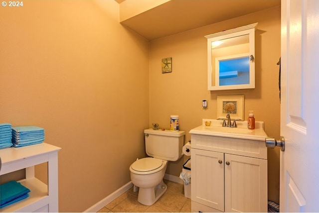 bathroom with tile patterned floors, vanity, and toilet