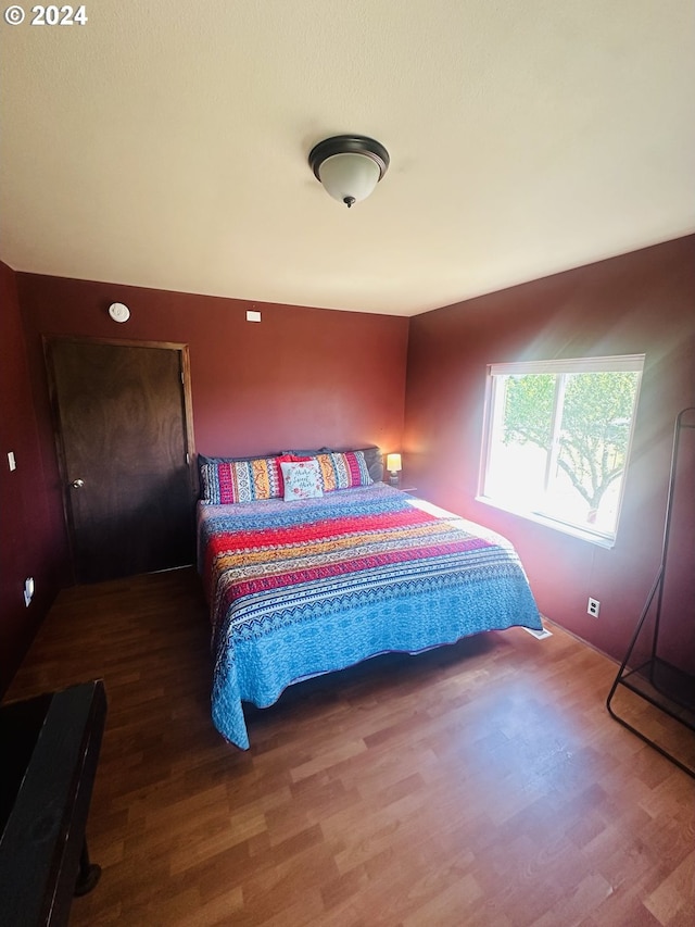 bedroom with hardwood / wood-style flooring