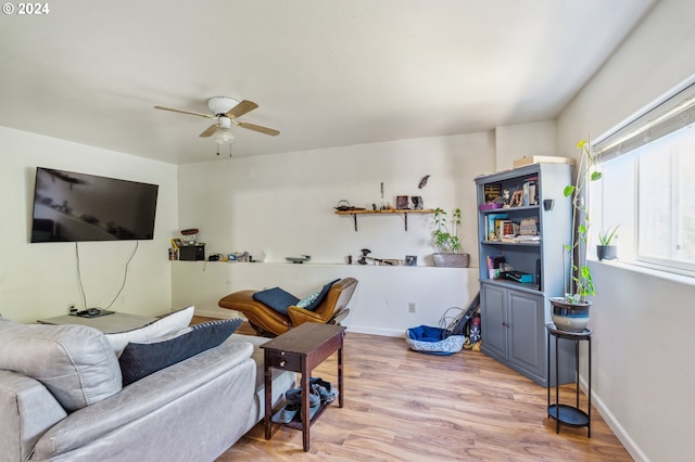 living room featuring ceiling fan and light hardwood / wood-style flooring