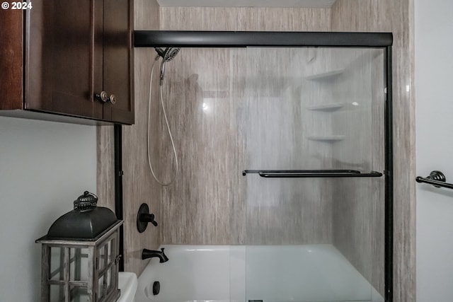 bathroom featuring shower / bath combination with glass door