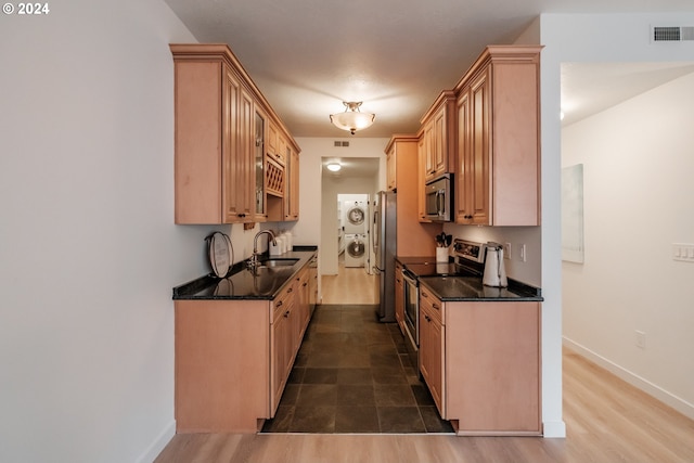 kitchen featuring light brown cabinetry, sink, stainless steel appliances, and hardwood / wood-style flooring