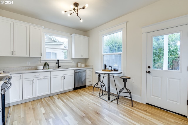 kitchen with a notable chandelier, appliances with stainless steel finishes, light hardwood / wood-style flooring, and white cabinets