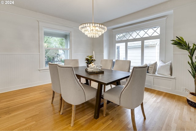 dining room featuring light hardwood / wood-style floors and a chandelier