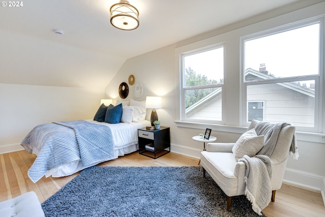 bedroom featuring wood-type flooring and vaulted ceiling