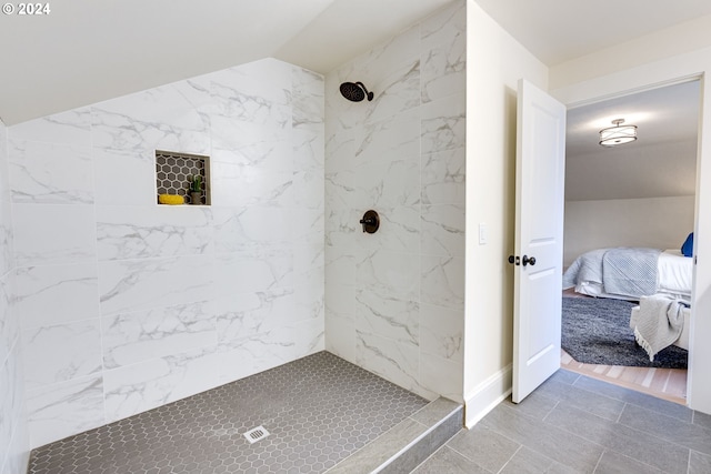 bathroom with hardwood / wood-style flooring and tiled shower