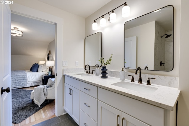 bathroom with vanity, hardwood / wood-style floors, and a shower